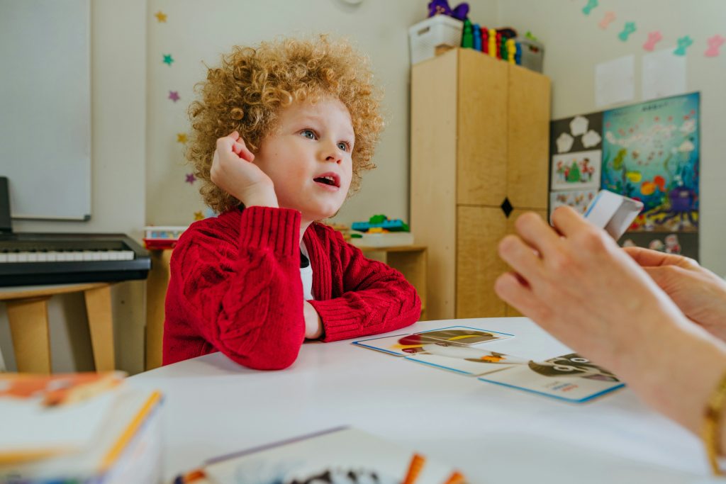 speech therapy page - kid going through a speech therapy session with a speech pathologist