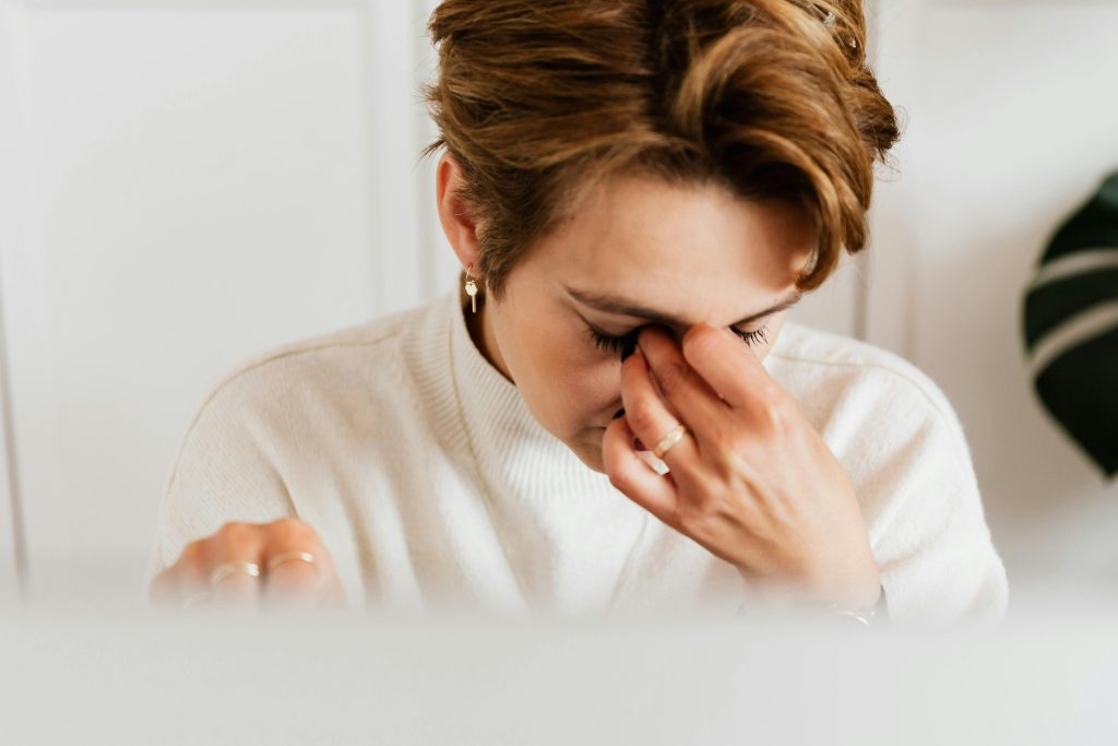 woman holding the bridge of her nose